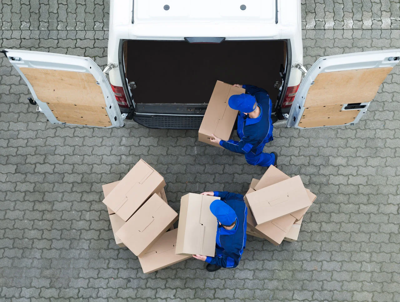 Boxes of printed garments being unloaded from a van